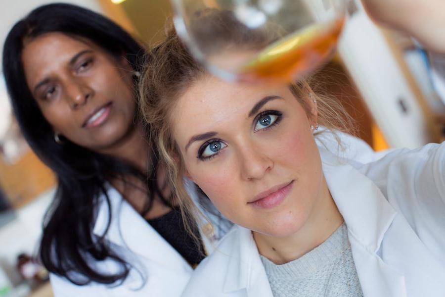 Image: A student and professor in a chemistry lab holding a test tube.